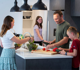 family cooking in kitchen