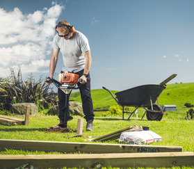 man using hole borer