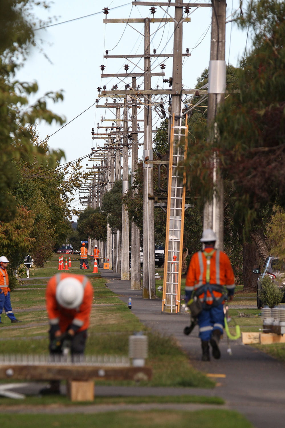Field crew working underneath overhead lines