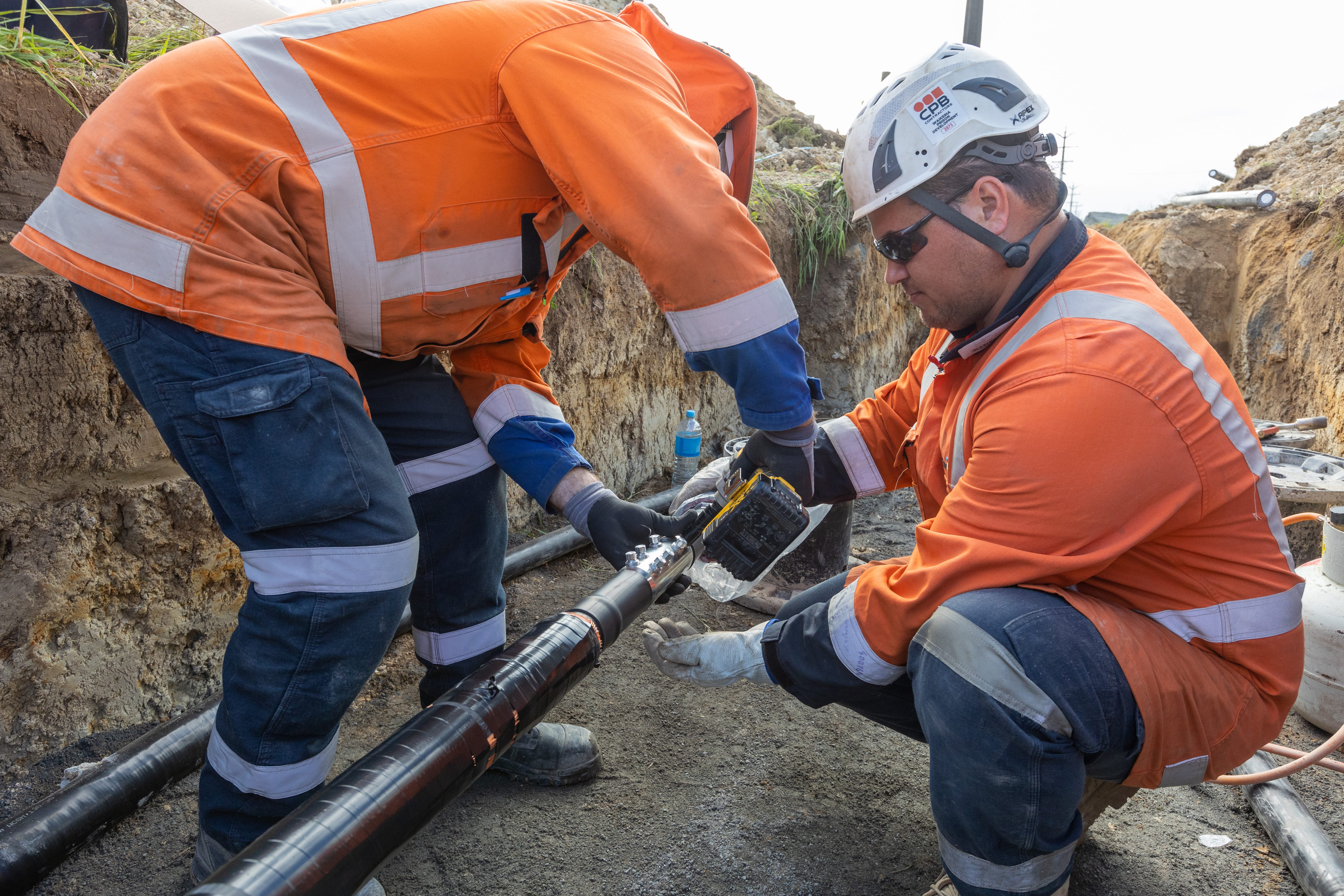 Fields crews doing cable jointing in a trench.